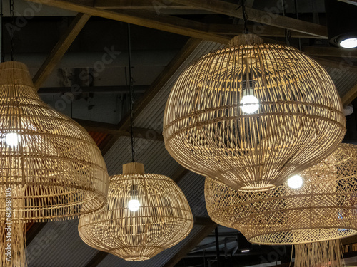 A woven bamboo lamp is a beautifully crafted lighting fixture that adds a touch of natural elegance to any space. Made from carefully selected bamboo strands, the lampshade is skillfully.close up.