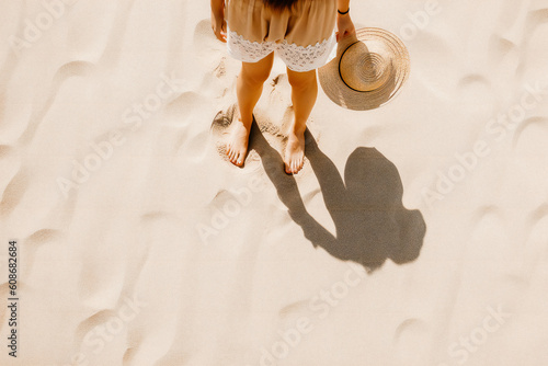 Child girl on the beach with a hat, ai generated