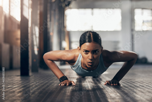 Fototapeta Naklejka Na Ścianę i Meble -  Push ups, workout and portrait of woman in gym for challenge, exercise and performance. Health, strong and sports with female bodybuilder training in fitness center for energy, wellness and focus