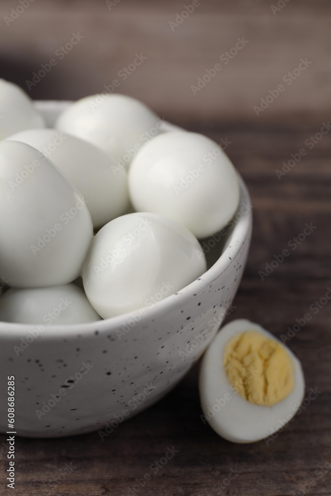 Many peeled hard boiled quail eggs in bowl on wooden table, closeup Many peeled hard boiled quail eggs in bowl on wooden table, closeup