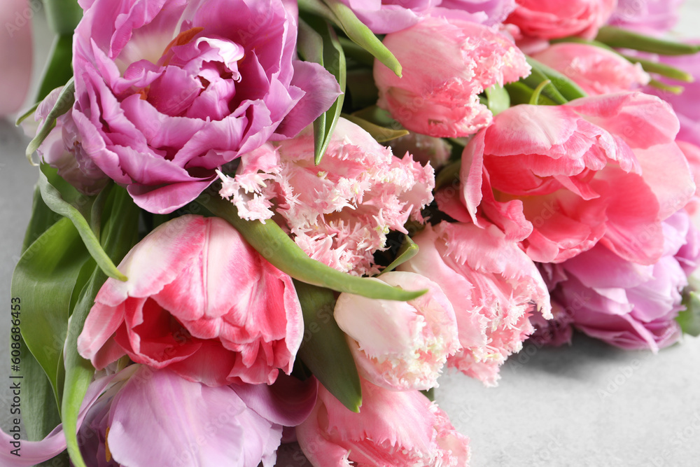 Beautiful bouquet of colorful tulip flowers on light gray table, closeup Beautiful bouquet of colorful tulip flowers on light gray table, closeup