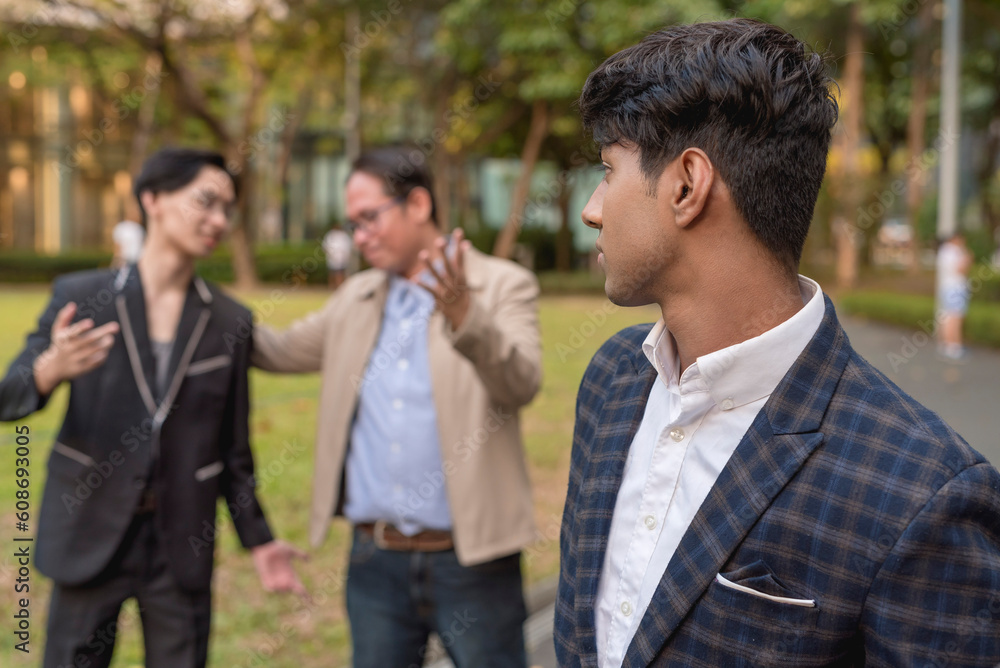 A man sulks after discovering his boss choosing and praising his co-worker while outside. Feeling depressed or jealous. Favoritism and discrimination in the workplace. A man sulks after discovering his boss choosing and praising his co-worker while outside. Feeling depressed or jealous. Favoritism and discrimination in the workplace.