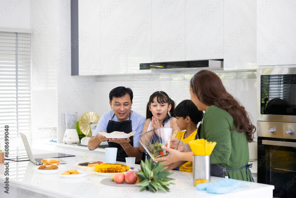 Happy family cooking together on kitchen. happy smiling parents enjoy weekend