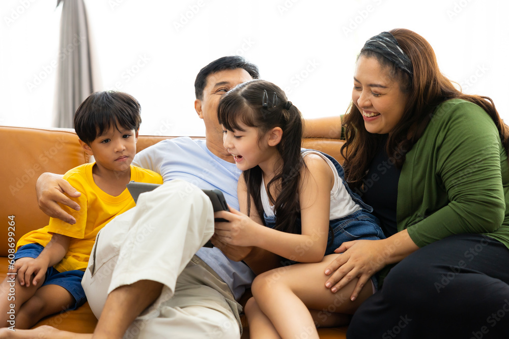 Together living room at home. Happy caucasian family parents relaxing  leisure time in living room at home.