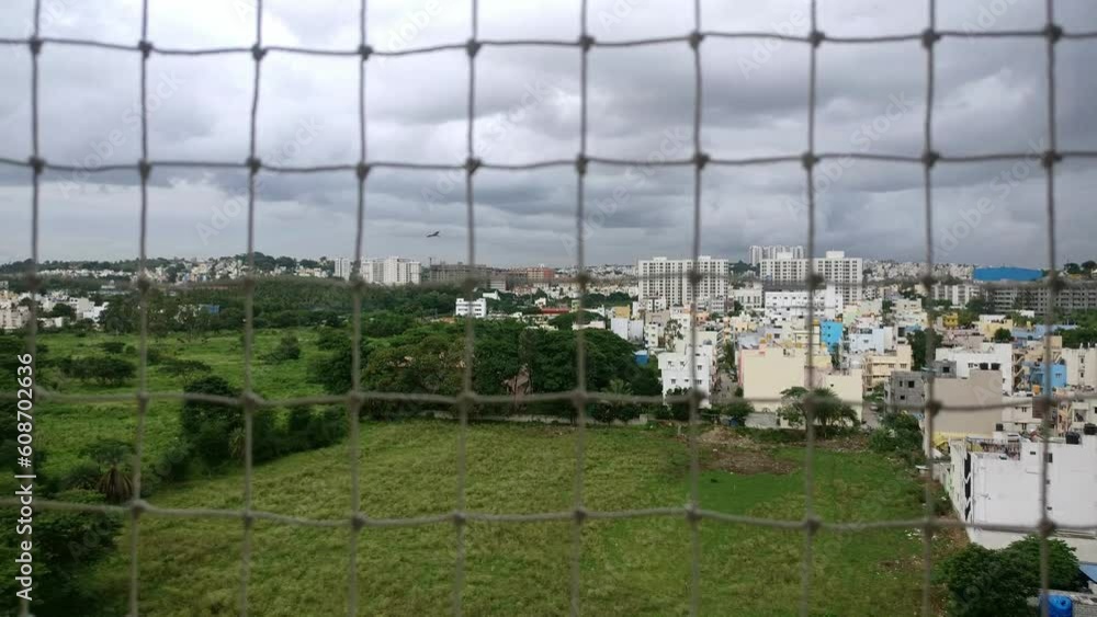 A view of city houses and skyscrapers from the top of a high-rise apartment building A view of city houses and skyscrapers from the top of a high-rise apartment building