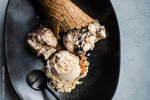 Cone with coffee balls and chocolate ice cream in a bowl