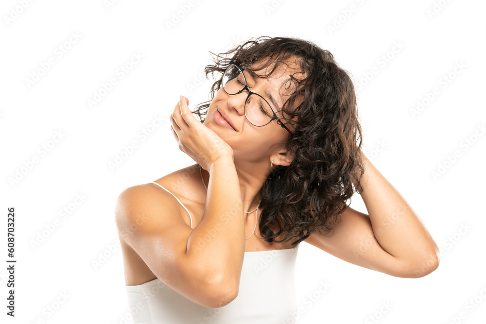 Obraz premium young woman cracking her neck on a white background