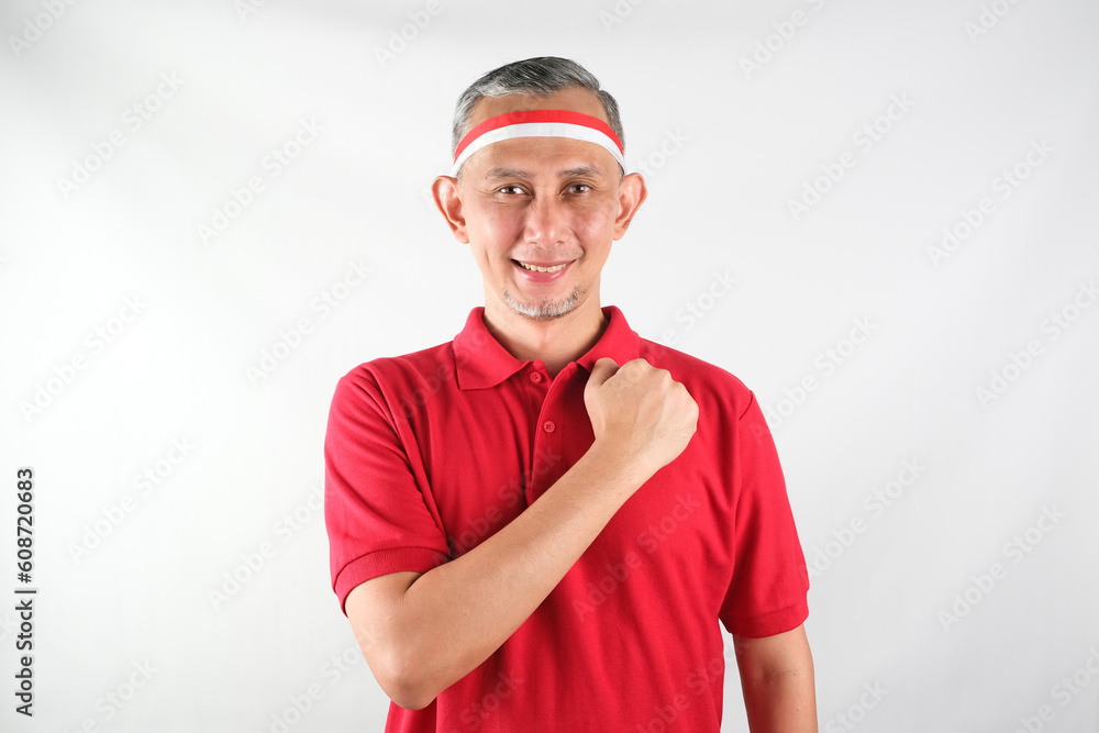 Portrait of Asian Man wearing red and white Indonesia flag attribute. Independence day concept.
