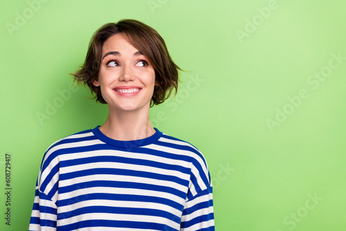 Wallpaper Mural Photo of cute lovely young lady beaming smile look side empty space wondering we