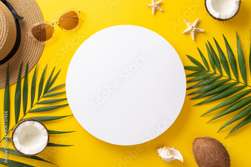 Indulge in the beauty of a summer getaway with this enchanting top view flat lay. Sunhat, palm leaves, sunglasses, starfish, seashell, and a coconut on a bright yellow background with blank circle