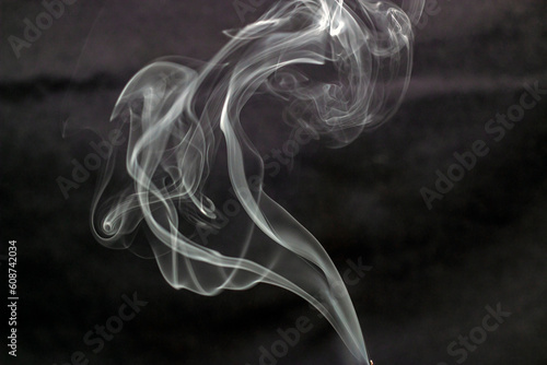 The smoke swirls from the incense 