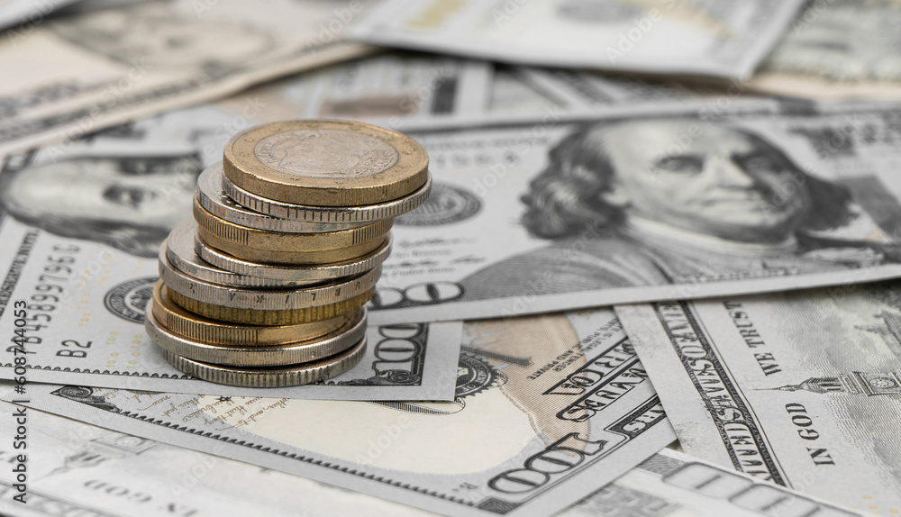 Stack of golden coins on dollar bills on a table. Stack of golden coins on dollar bills on a table.