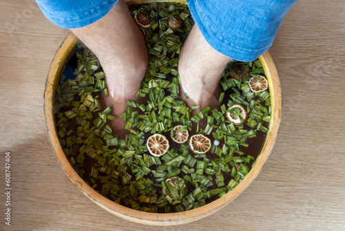 A man soaks his feet in an herbal bath