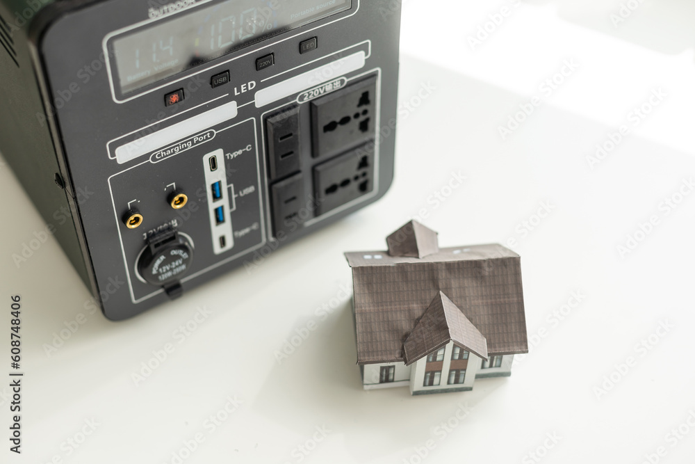 Obraz premium Portable power station charging devices on floor in living room