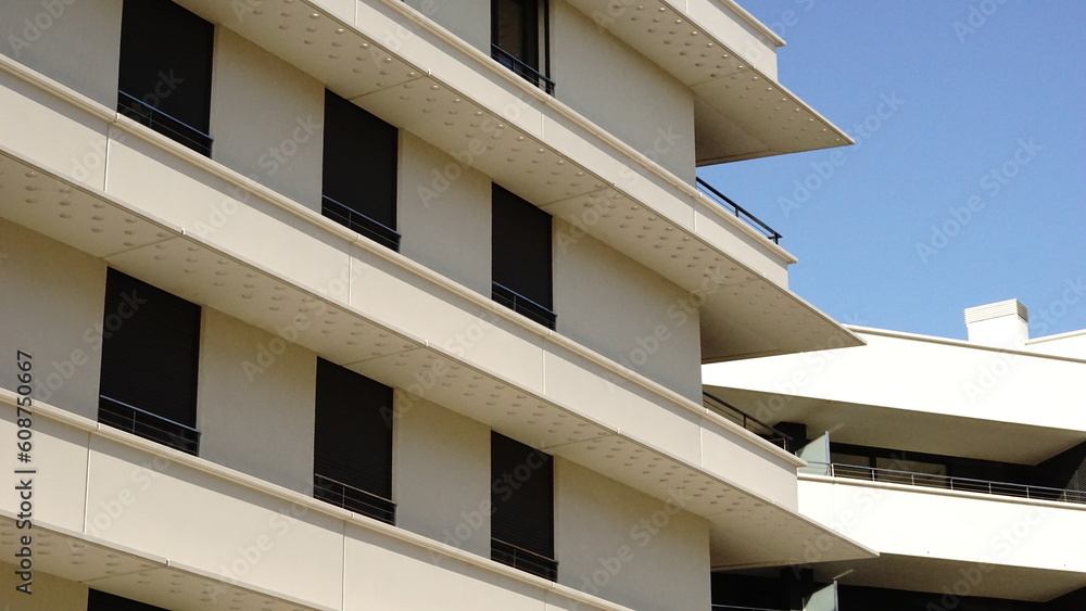 white residential buildings facade against the sky white residential buildings facade against the sky