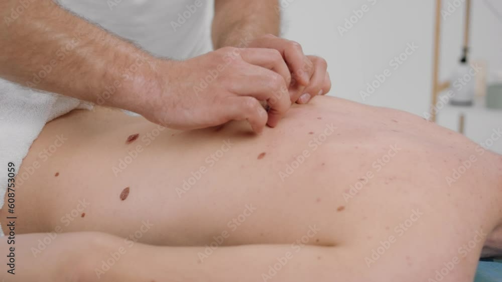 Taking details closeup the masseur man doing professional back massage for muscles to his client at spa salon or massage room Taking details closeup the masseur man doing professional back massage for muscles to his client at spa salon or massage room