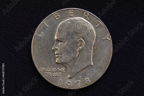 Portrait of the President of USA Dwight D. Eisenhower on the one dollar USA coin issued in 1978, isolated on grey cloth background photo