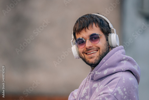 smiling young man with headphones © carballo