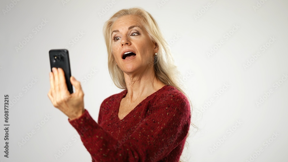 Portrait of charming middle aged woman talking on smartphone by video chat conference meeting. Remote work freelance or distance relatshionship. Portrait of charming middle aged woman talking on smartphone by video chat conference meeting. Remote work freelance or distance relatshionship.