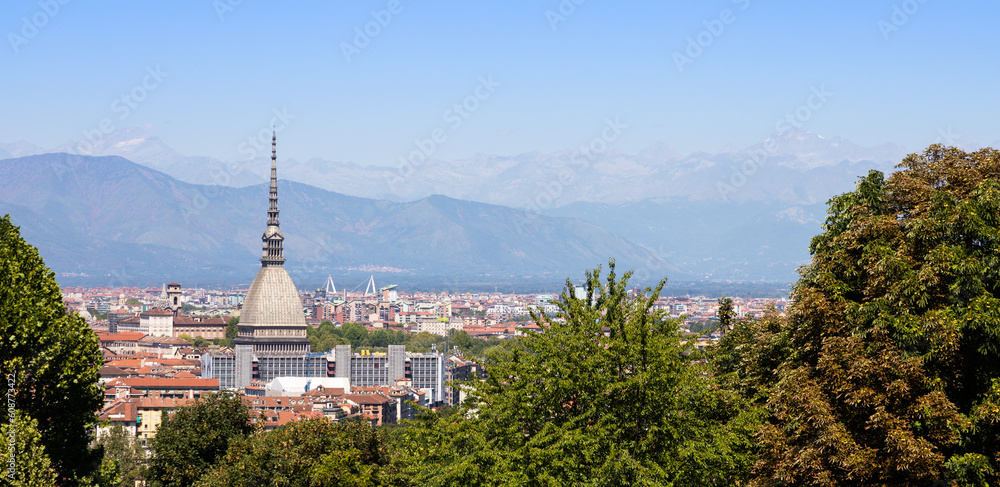 Turin - Italy - Urban skyline with Mole Antonelliana building, blue sky and Alps mountains.