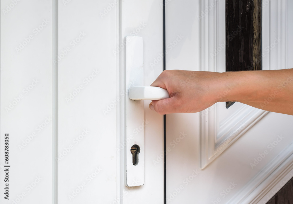 Fototapeta premium front door. hand holds doorknob on front door PVC 