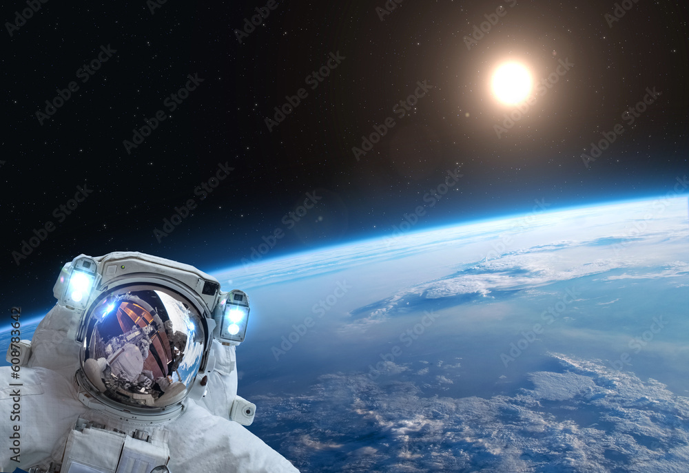 Astronaut, Earth and Sun. Astronaut at spacewalk over of the blue planet Earth. Elements of this image furnished by NASA. Astronaut, Earth and Sun. Astronaut at spacewalk over of the blue planet Earth. Elements of this image furnished by NASA.
