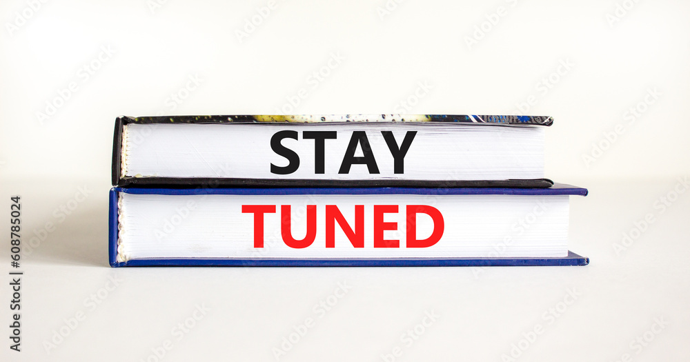 Stay tuned symbol. Concept words Stay tuned on beautiful books on a beautiful white table white background. Business, support, motivation, psychological and stay tuned concept. Copy space.
