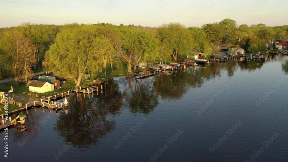 Aerial view of the Midwest during spring summer season. River, Midwestern houses with a private dock, fishing boats Aerial view of the Midwest during spring summer season. River, Midwestern houses with a private dock, fishing boats