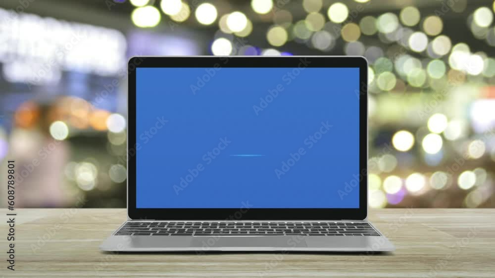 Power button icon on modern laptop computer screen on wooden table over blur light and shadow of shopping mall, Business start up online concept Power button icon on modern laptop computer screen on wooden table over blur light and shadow of shopping mall, Business start up online concept