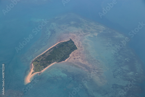 Tropical paradise beautiful island viewed from above, aerial view on crystal clear turquoise blue and green waters, amazing romantic touristic destination, shore of Mozambique