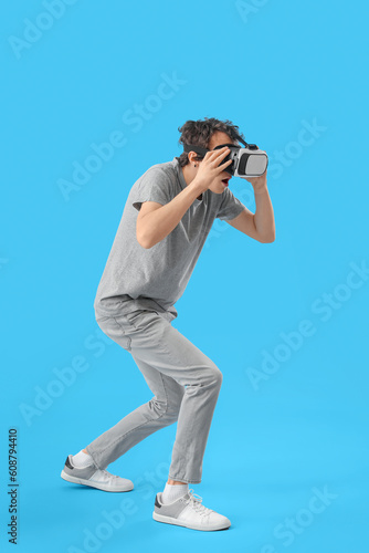 Young man using VR glasses ...