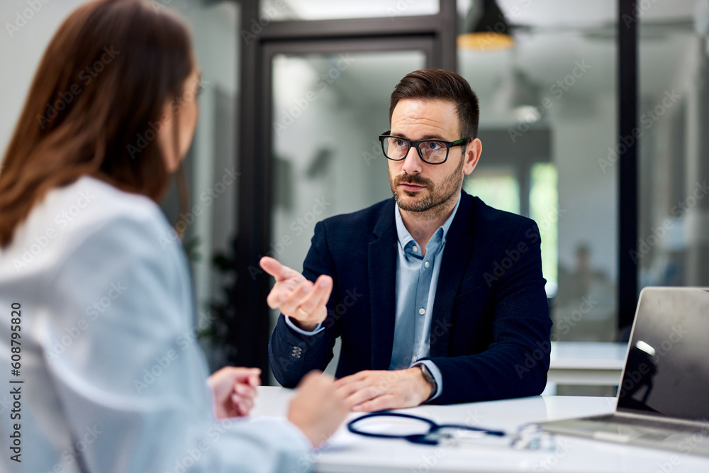 A man talking with a female doctor about his health condition, elegantly dressed. A man talking with a female doctor about his health condition, elegantly dressed.
