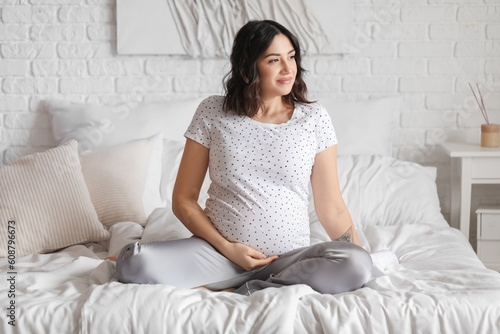 Serene pregnant woman sitti...