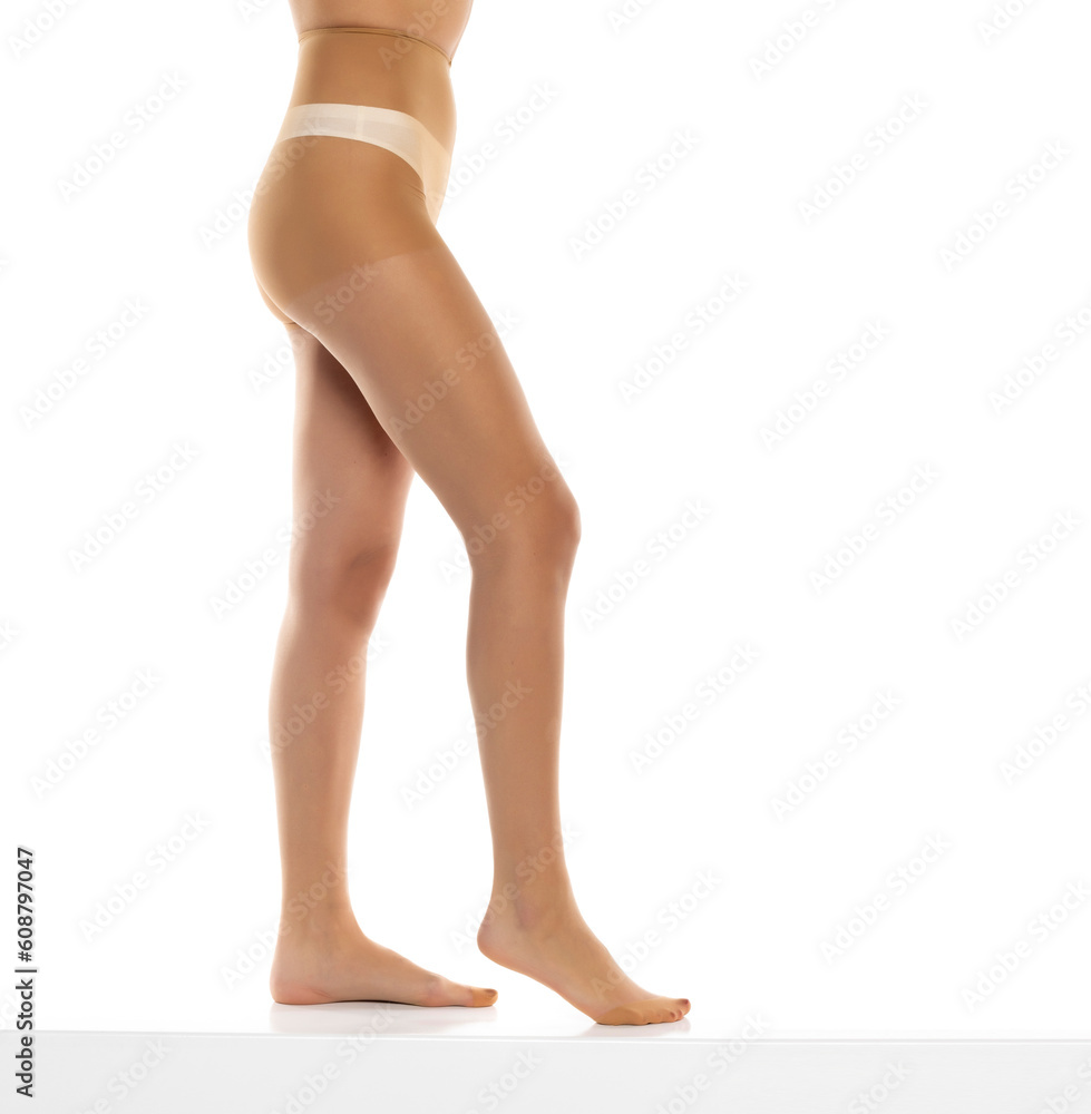 Woman wearing tights isolated on white, closeup of legs on a white background. Profile, side view Woman wearing tights isolated on white, closeup of legs on a white background. Profile, side view