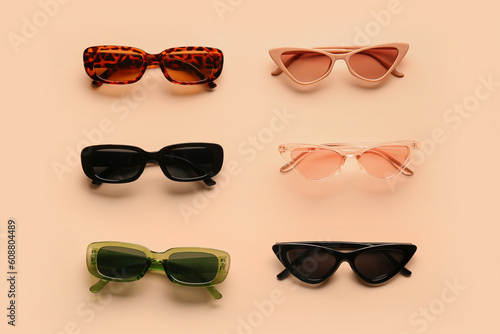 Stylish sunglasses on beige...