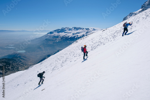 mountaineers climbing harmoniously on the steep and sloping summit