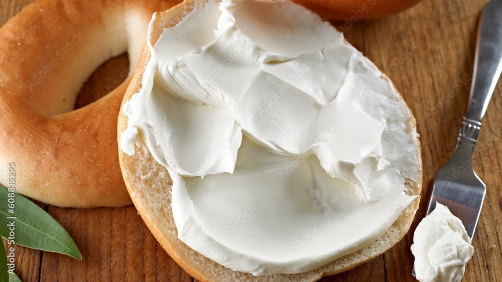 Savory Delights: Close-Up of Cream Cheese-Spread Bagel on a Delectable Food Background in Stunning 4K Savory Delights: Close-Up of Cream Cheese-Spread Bagel on a Delectable Food Background in Stunning 4K
