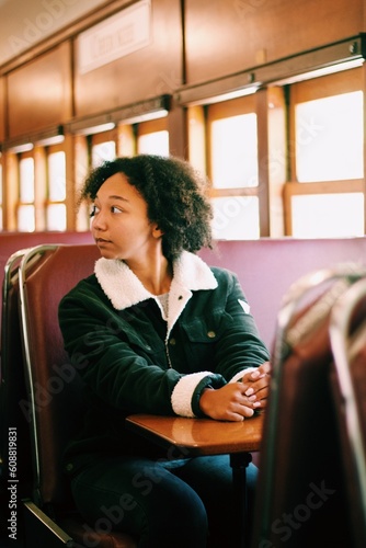 woman sitting on a chair on a train