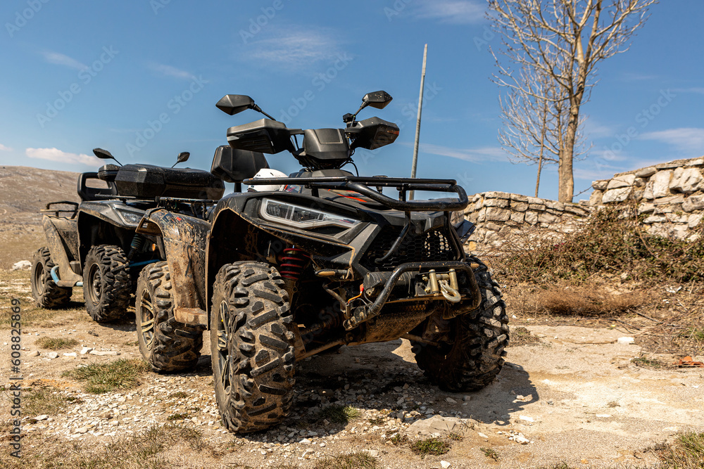 4x4 Quad motorbikes parking offroad in front of a mountain landscape in spring outdoors 4x4 Quad motorbikes parking offroad in front of a mountain landscape in spring outdoors