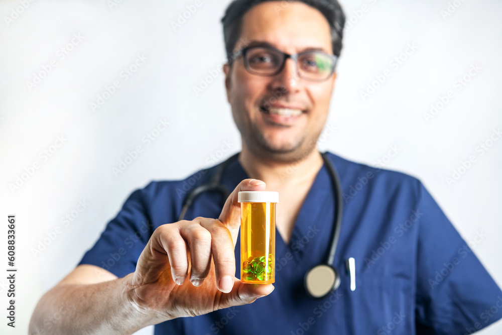 Happy and friendly male medical doctor offers a bottle of pills to a client with a smile. Smiling and positive healthcare consultant holding pill bottle Happy and friendly male medical doctor offers a bottle of pills to a client with a smile. Smiling and positive healthcare consultant holding pill bottle