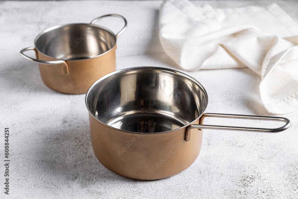Set of cookware on the table. Metallic pans. Set of cookware on the table. Metallic pans.