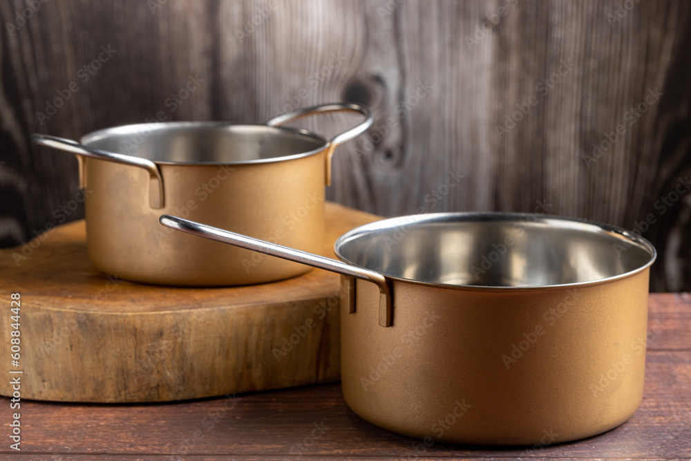 Set of cookware on the table. Metallic pans. Set of cookware on the table. Metallic pans.