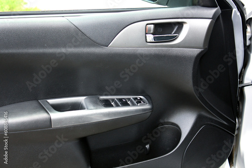 Window control buttons in modern car. Car window control panel. Modern car window switch. Door handle with power window control. © Best Auto Photo