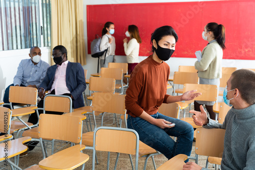 Students wearing protective mask in university classroom