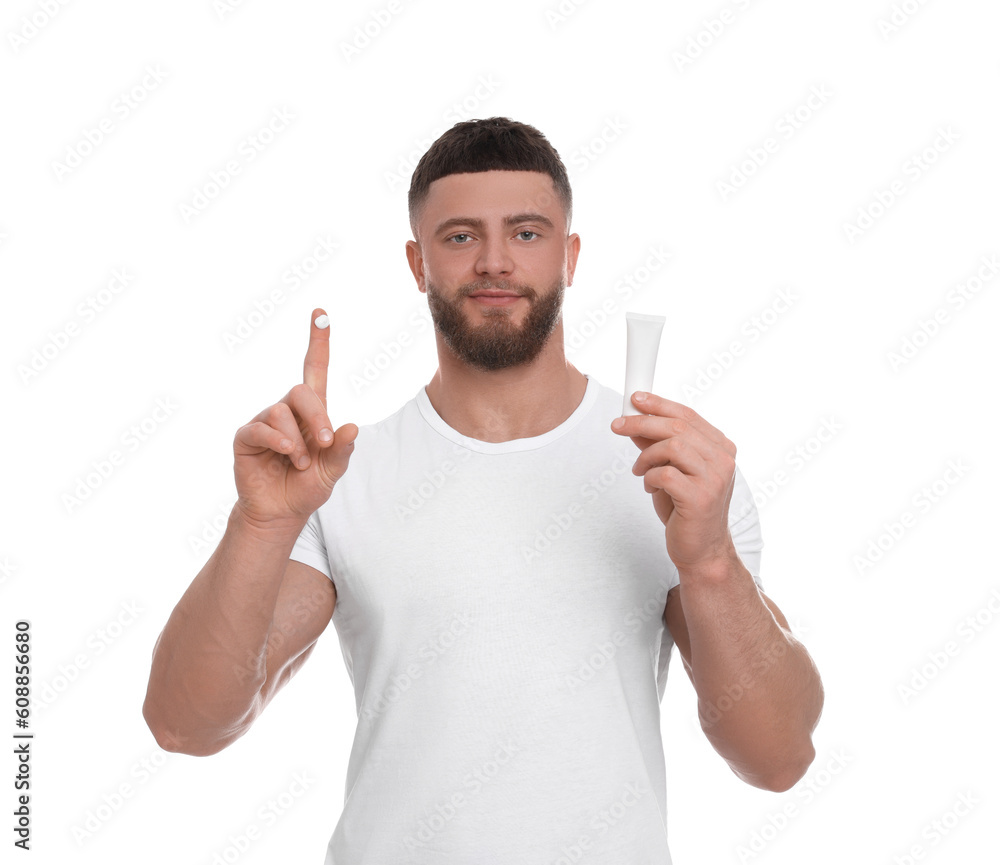 Handsome man with tube of body cream on white background Handsome man with tube of body cream on white background