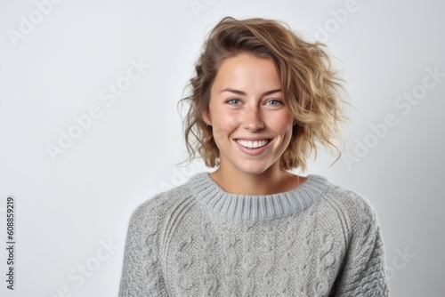 Portrait of a smiling young woman with blond hair on white background