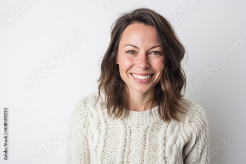 Portrait of a young woman smiling at the camera on a white background