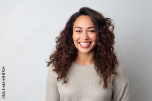 Portrait of a beautiful young woman smiling and looking at camera.