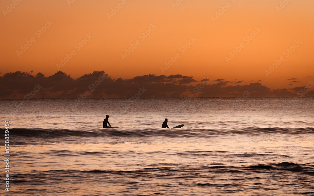 two surfers waiting