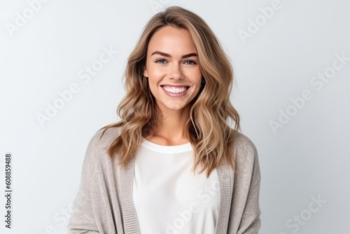 Portrait of a beautiful young woman smiling at camera isolated on a white background